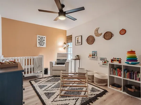 a living room with furniture and a book shelf