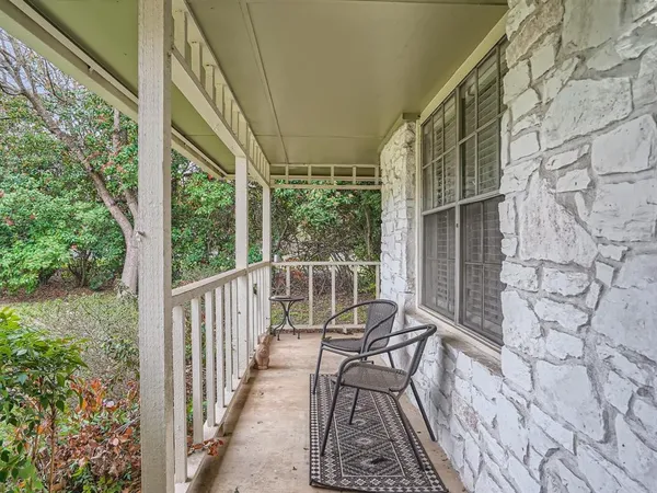 a view of a balcony with chairs