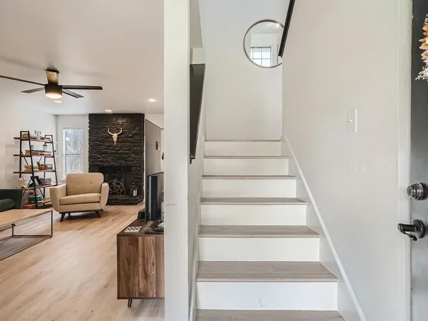 a view of a livingroom with furniture and staircase