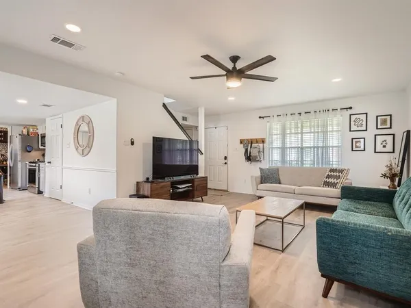 a living room with fireplace furniture and a flat screen tv