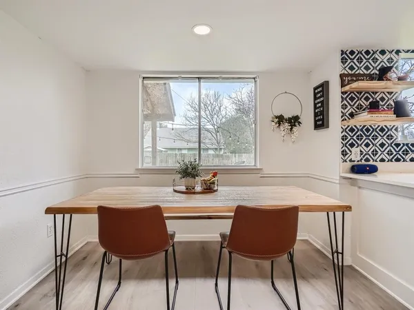 a dining room with furniture and window