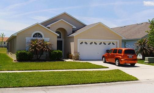 683 Eagle Pointe South Kissimmee, FL 34746 - Photo 1 of 1 a front view of a house with a garden