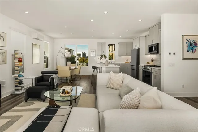 a living room with furniture kitchen area and a couch