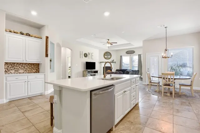 a view of a dining room with furniture and chandelier