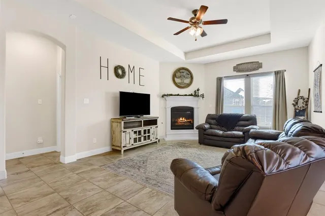 a living room with furniture a clock and a fireplace