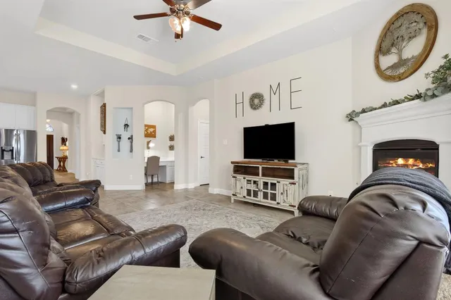 a bedroom with a bed a couch and a window