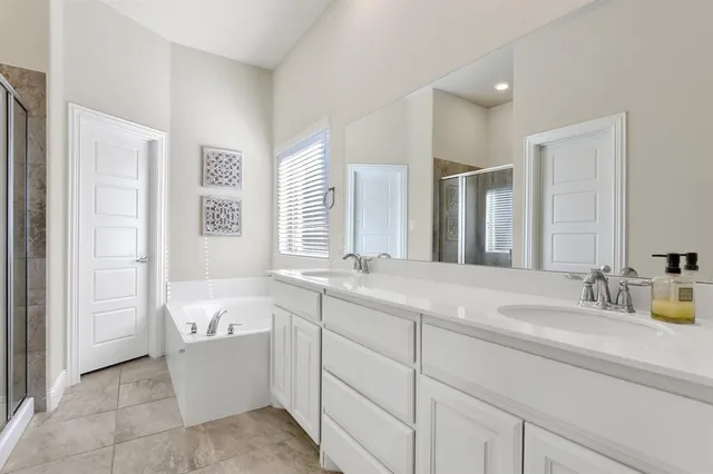 a bathroom with a bathtub and a shower