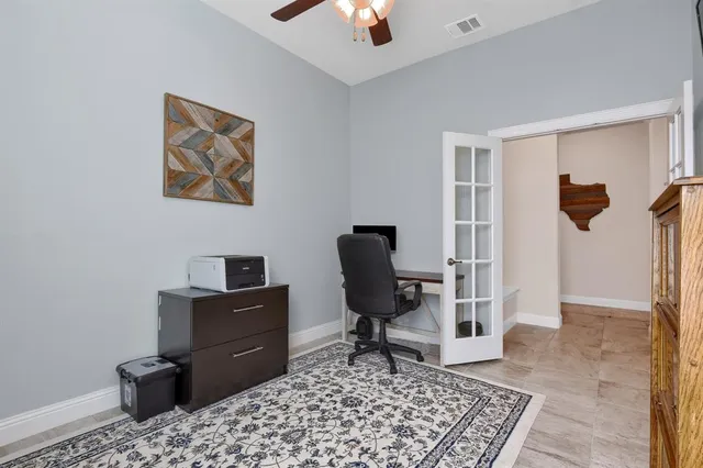 a bedroom with a bed and a chandelier fan