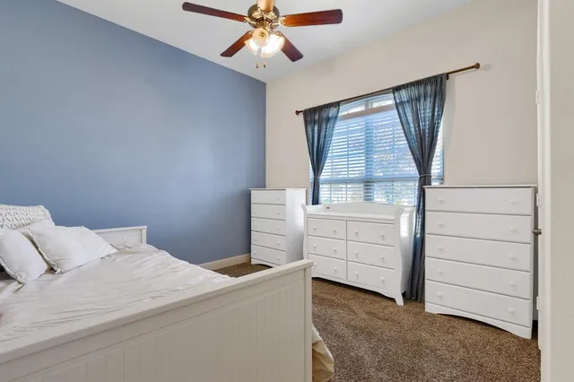 a bedroom with a bed and a dresser