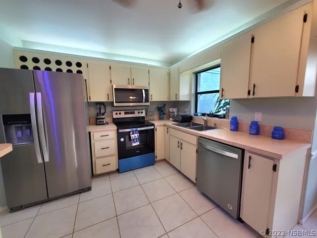 a kitchen with stainless steel appliances granite countertop a refrigerator sink and cabinets