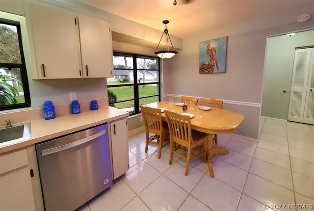 a kitchen with stainless steel appliances a sink and a refrigerator