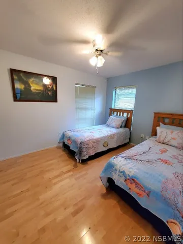 a bedroom with two beds and a chandelier