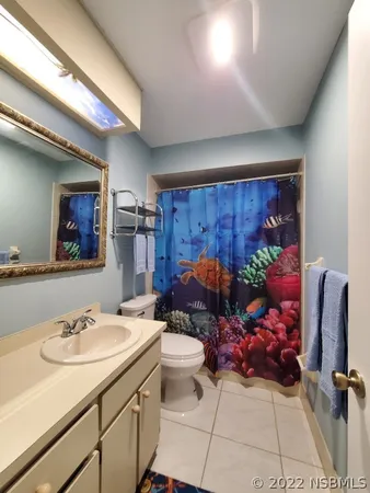 a bathroom with a sink mirror and toilet