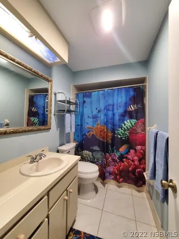 a bathroom with a sink mirror and toilet