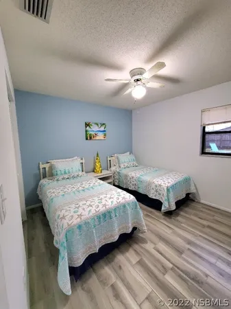 a bedroom with bed and a chandelier