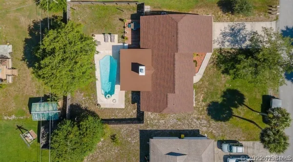 an aerial view of a house with a yard