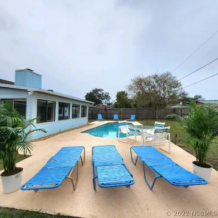 a view of swimming pool with lounge chair