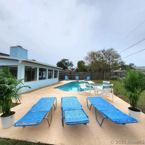a view of swimming pool with lounge chair