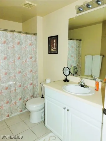a bathroom with a sink toilet and a mirror