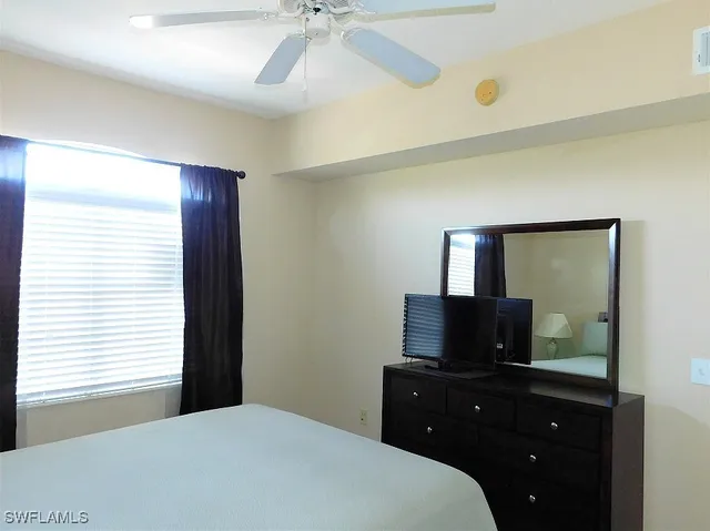 a bedroom with a bed and a television