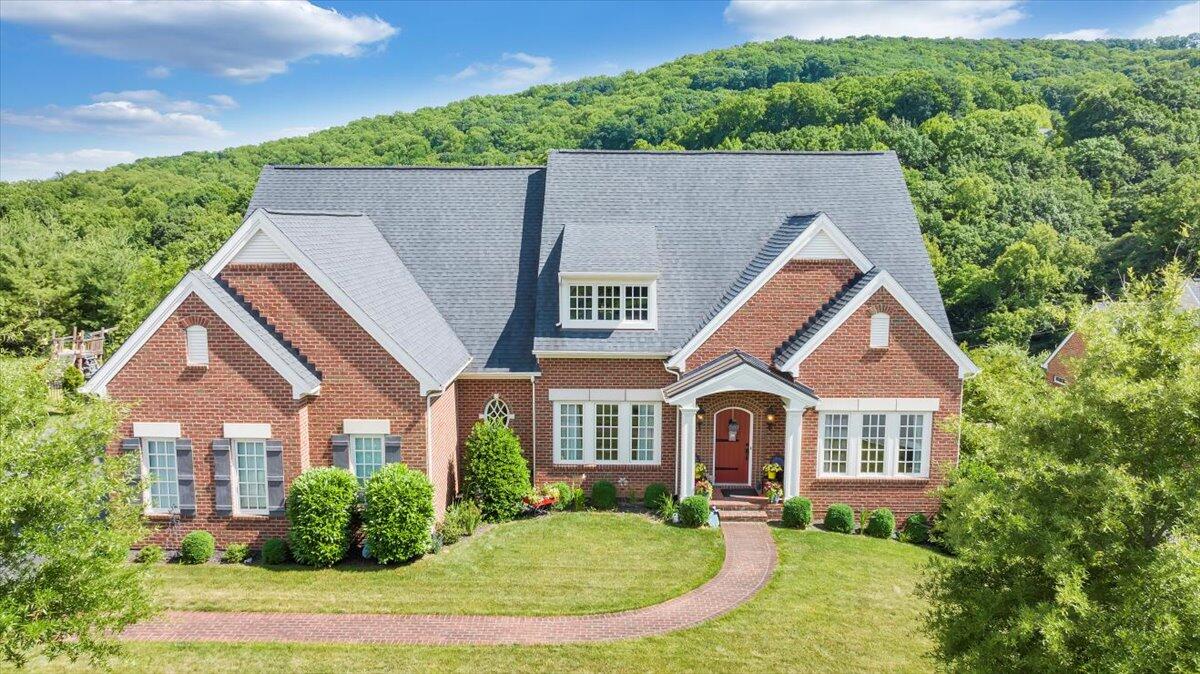 a aerial view of a house with yard and green space