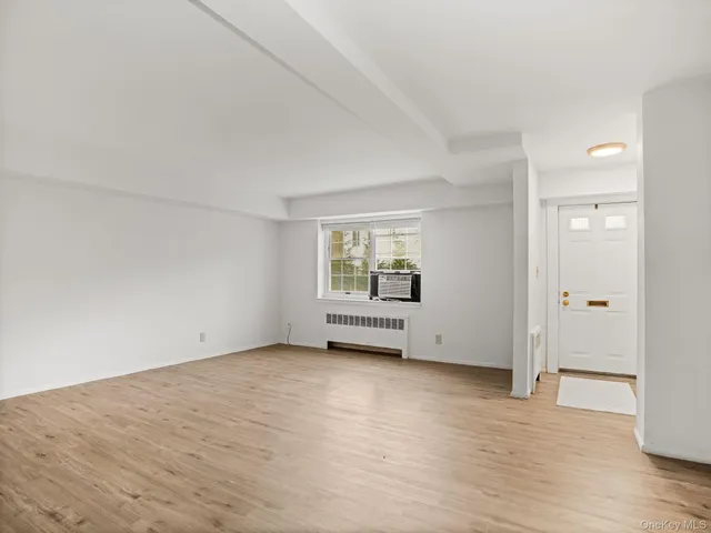 a view of an empty room and wooden floor