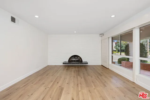 a view of a room with wooden floor and window