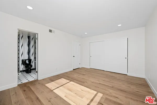 a view of a room with wooden floor and closet