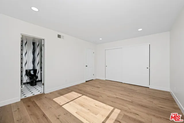 a view of a room with wooden floor and closet