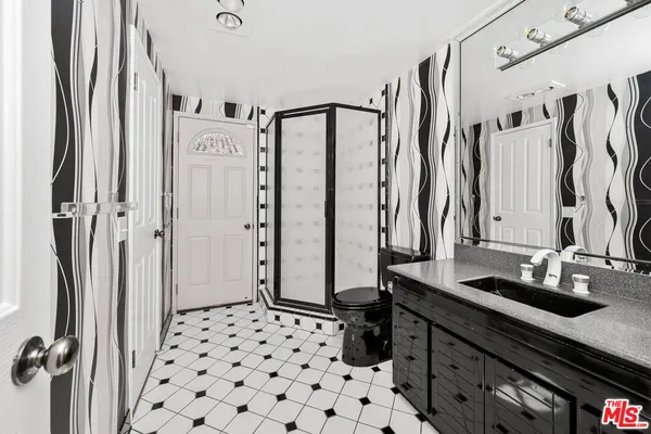 a bathroom with a shower and a sink