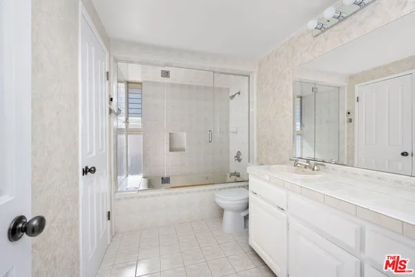 a bathroom with a double vanity sink mirror double and shower