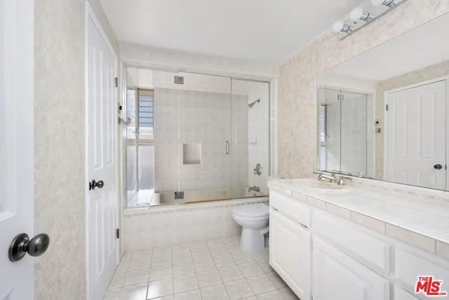 a bathroom with a double vanity sink mirror double and shower