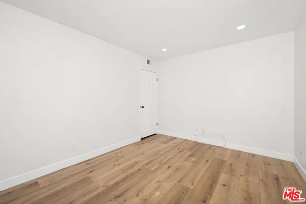 an empty room with wooden floor