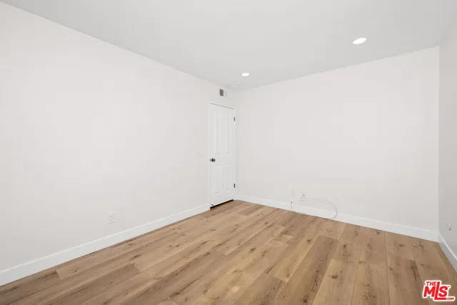 an empty room with wooden floor