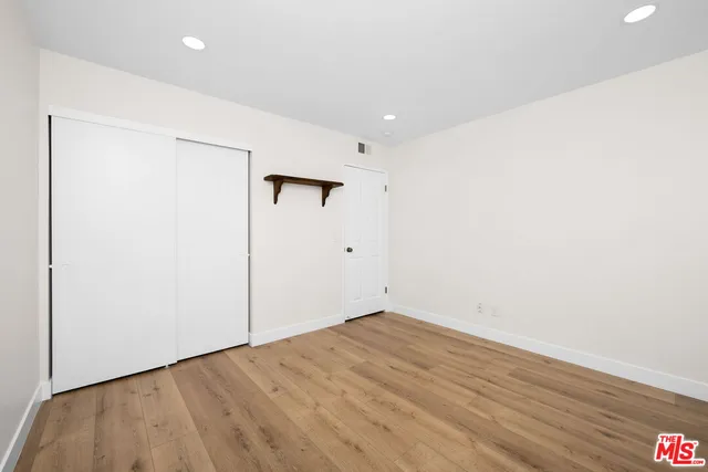 an empty room with wooden floor