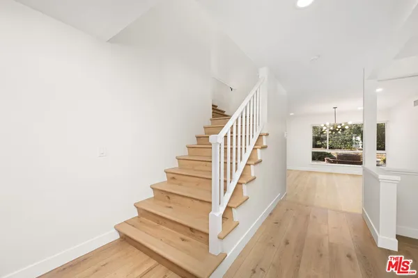 a view of entryway and hall with wooden floor