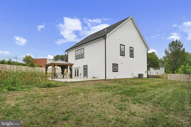 a view of a white house with a yard