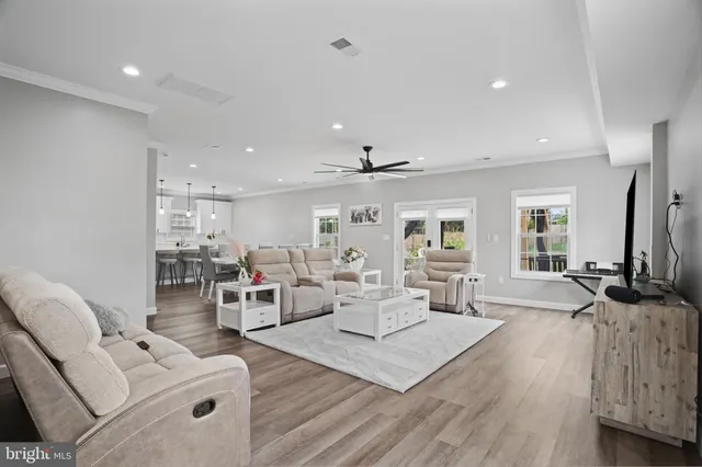 a living room with furniture and wooden floor
