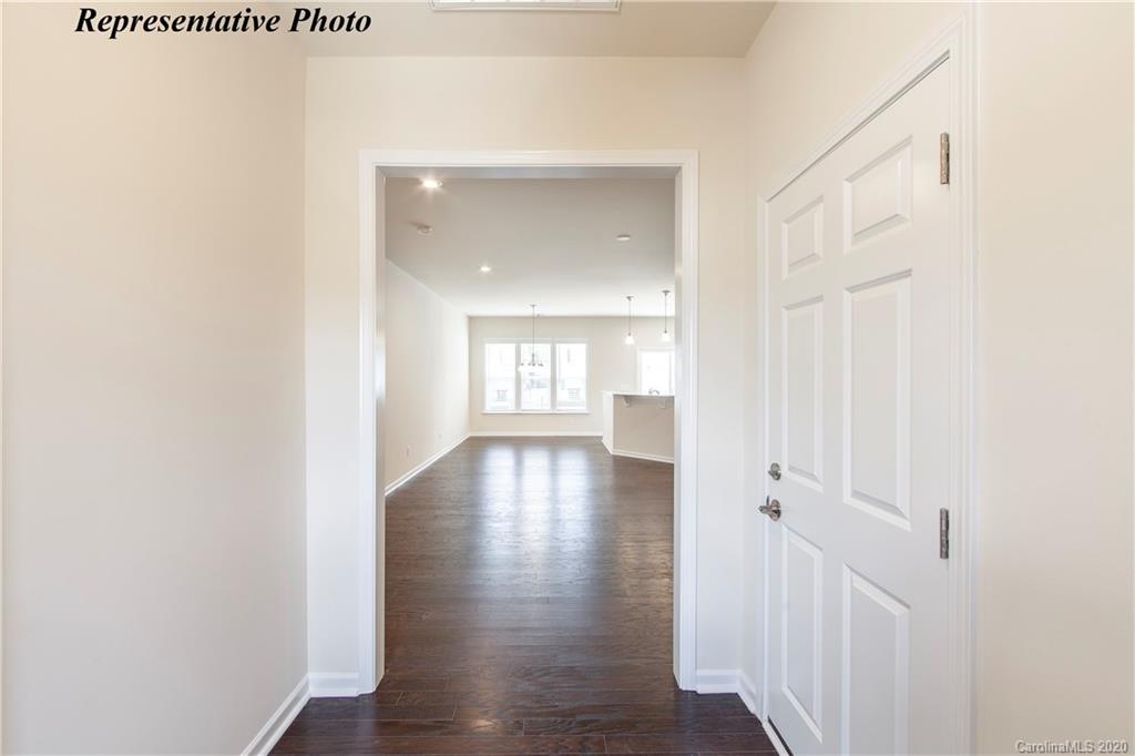475 Hunters Dance Road, Unit 337 Fort Mill, SC 29708 - Photo 2 of 22 a view of a hallway with wooden floor and closet