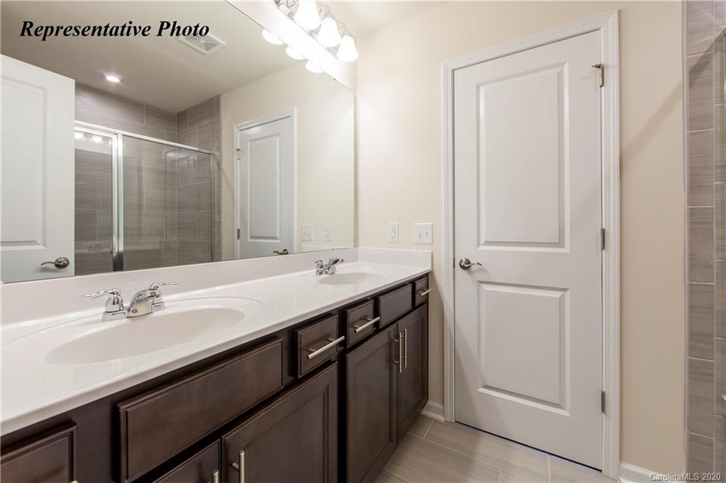 475 Hunters Dance Road, Unit 337 Fort Mill, SC 29708 - Photo 15 of 22 a bathroom with a double vanity sink a and mirror