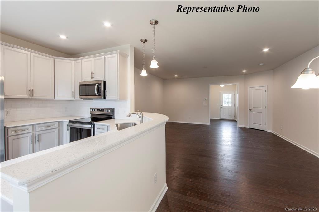 475 Hunters Dance Road, Unit 337 Fort Mill, SC 29708 - Photo 9 of 22 a kitchen with stainless steel appliances a refrigerator sink and cabinets