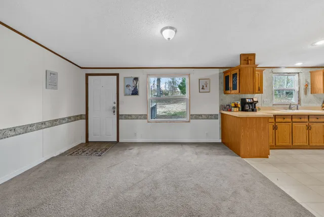 a view of a kitchen with fridge and sink