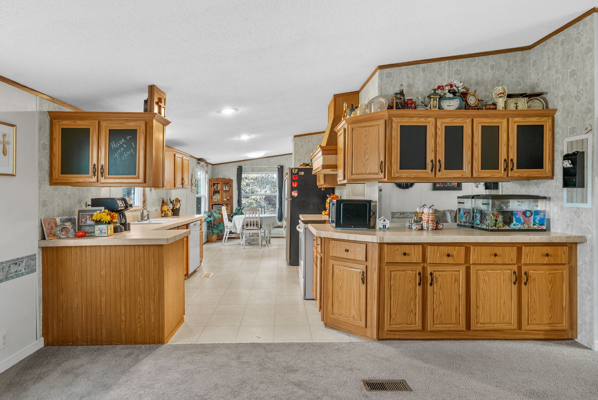 197 Old Homestead Road Big Sandy, TN 38221 - Photo 13 of 59 a kitchen with stainless steel appliances granite countertop a stove and cabinets
