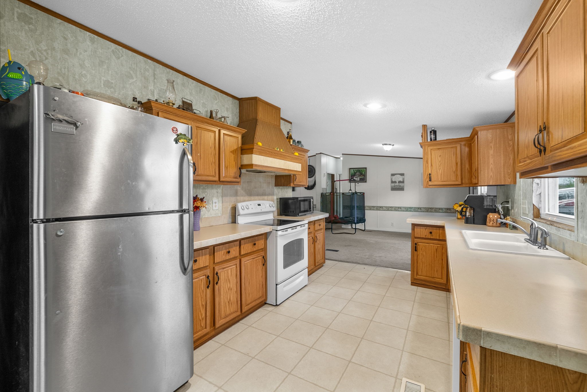 197 Old Homestead Road Big Sandy, TN 38221 - Photo 16 of 59 a kitchen with stainless steel appliances granite countertop a refrigerator a stove a sink and a refrigerator