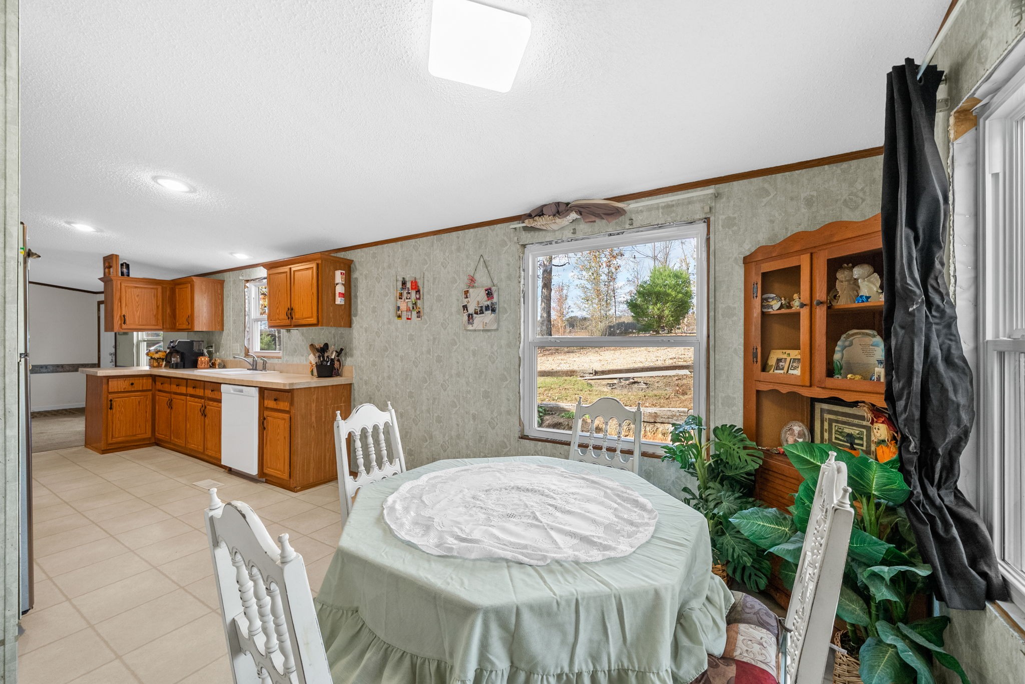 197 Old Homestead Road Big Sandy, TN 38221 - Photo 18 of 59 a kitchen with stainless steel appliances granite countertop a stove a sink dishwasher and a refrigerator with wooden floor