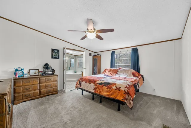 a bed room with a bed and a chandelier