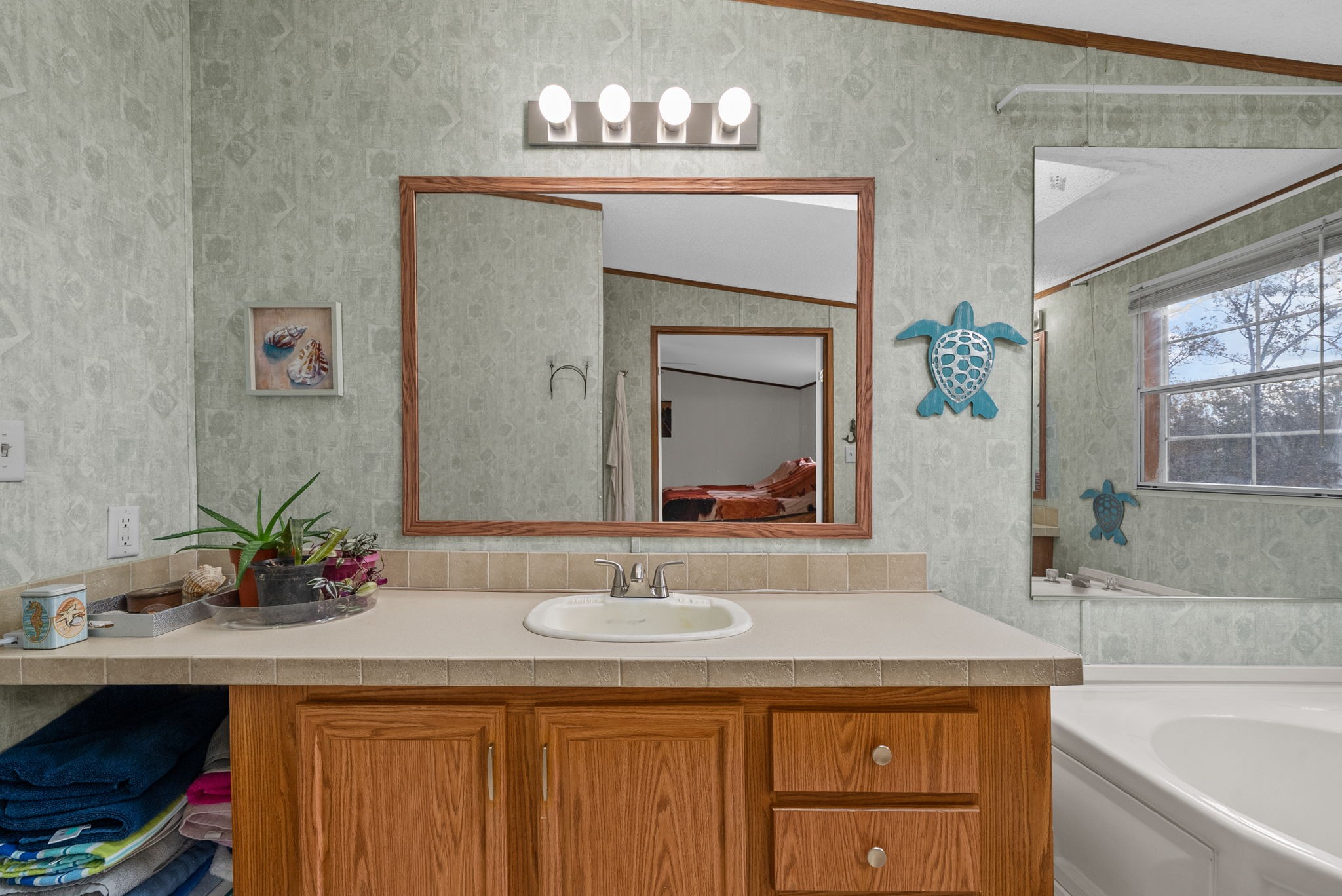 197 Old Homestead Road Big Sandy, TN 38221 - Photo 23 of 59 a bathroom with a sink and a mirror
