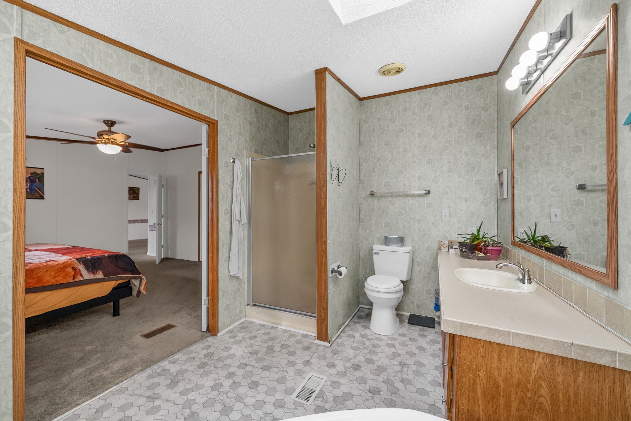 197 Old Homestead Road Big Sandy, TN 38221 - Photo 24 of 59 a en suite bathroom with a granite countertop sink and a mirror
