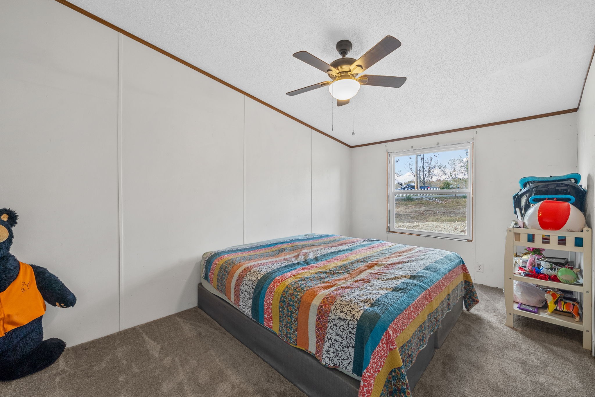 197 Old Homestead Road Big Sandy, TN 38221 - Photo 25 of 59 a bedroom with a bed and a chandelier