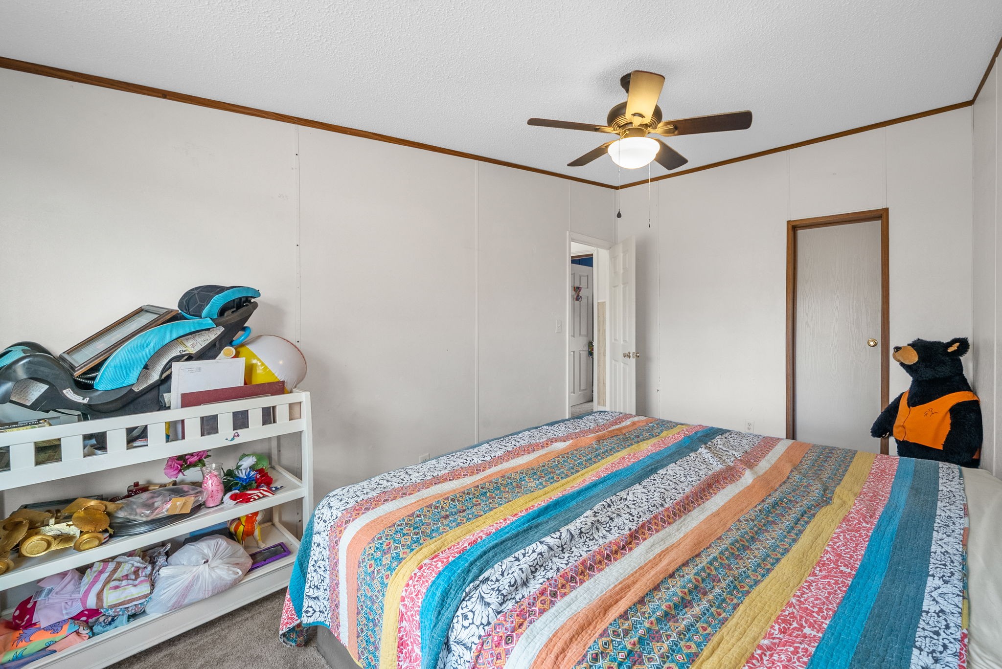 197 Old Homestead Road Big Sandy, TN 38221 - Photo 26 of 59 a bedroom with a bed and a book shelf